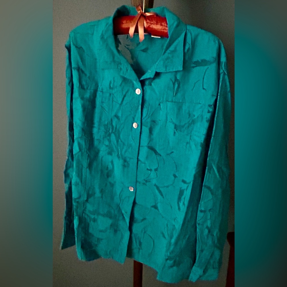 Beautiful  teal blouse with sheer flower design.  Perfect  to wear all season!